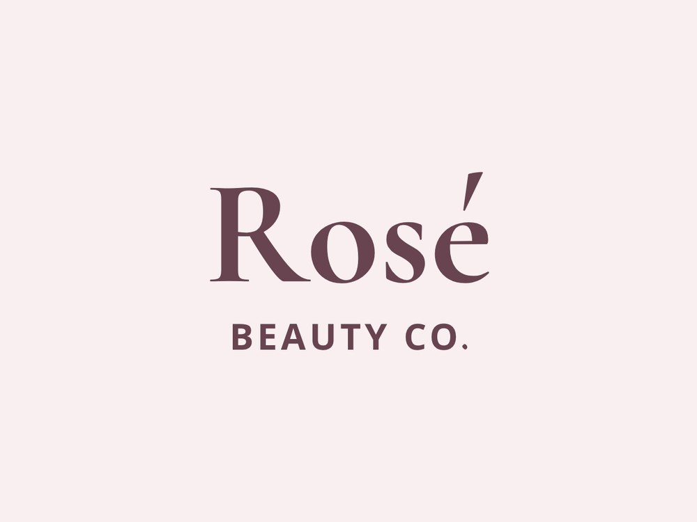 Rosé Beauty Co. serif wordmark in deep plum on blush